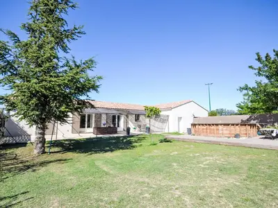 a white house with a tree in the yard at Holiday Home L' amandier by Interhome in Saint-Didier