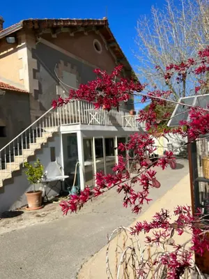 a house with pink flowers in front of it at 