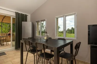 a kitchen with a dining room table and chairs at SmartStay Mas Les Cedres - Proche Isle-sur-la-Sorgue in Lagnes