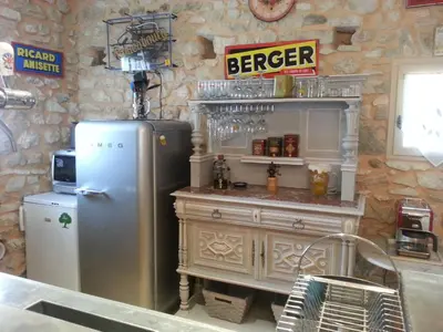 a kitchen with a refrigerator and a counter at Le Coin Retro pour séjour romantique avec piscine chauffée in Le Thor