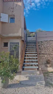 a set of stairs leading to a building at Le jardin des oliviers in Apt