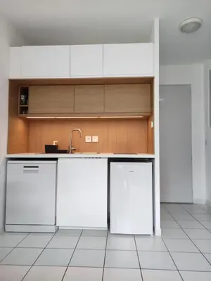 a kitchen with white cabinets and a sink at La provençale in Saint-Saturnin-lès-Avignon