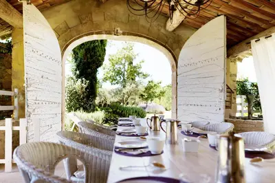 a dining room with a long table and chairs at Domaine de Canfier, maison d'hôtes in Robion en Luberon