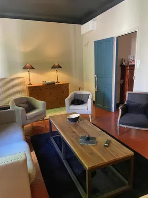 a living room with couches and a coffee table at La Capucine in Cavaillon