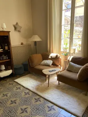 a living room with a couch and a table at La Capucine in Cavaillon
