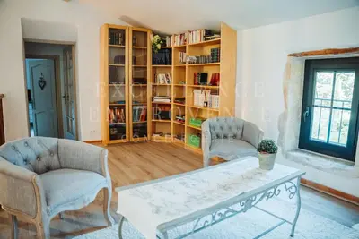 a living room with two chairs and a table at Mas de l'air in Noves