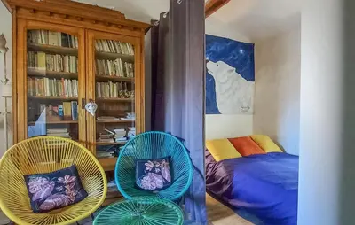 a bedroom with two chairs and a bed in it at 3 Bedroom Awesome Home In Carpentras in Carpentras