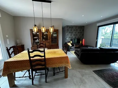 a living room with a table and a couch at Le refuge des oiseaux in Lourmarin