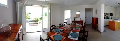a dining room with a long table with chairs at Villa Lambesc Provence in Lambesc