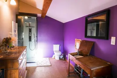 a purple bathroom with a toilet and a sink at JAS provençal pour 6 personnes à 2mn de la Grange de Javon in Monieux
