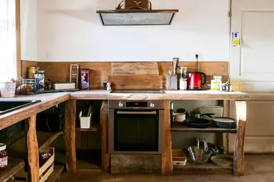 a kitchen with a wooden counter top with a stove at JAS provençal pour 6 personnes à 2mn de la Grange de Javon in Monieux