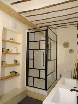 a bathroom with a glass shower in a room at Maison avec terrasse panoramique in Châteauneuf-de-Gadagne