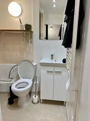 a bathroom with a white toilet and a sink at Studio centre historique à Carpentras in Carpentras