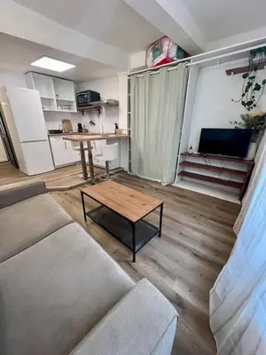 a living room with a couch and a table at Studio centre historique à Carpentras in Carpentras