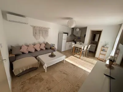 a living room with a couch and a table at Maison de vacances en campagne in Cavaillon