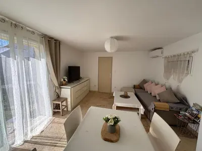 a living room with a couch and a table at Maison de vacances en campagne in Cavaillon
