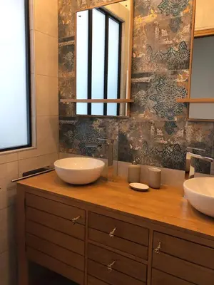 a bathroom with two sinks and a large mirror at L'Oustalet des Alpilles in Saint-Rémy-de-Provence