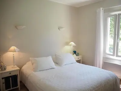 a bedroom with a bed with white sheets and a window at Holiday Home in Villes-sur-Auzon with Pool in Villes-sur-Auzon