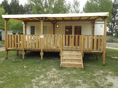 a wooden gazebo with a porch and a deck at Mobil Home au calme Camping 4 Cadenet in Cadenet