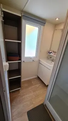 a small bathroom with a sink and a window at Mobil Home au calme Camping 4 Cadenet in Cadenet