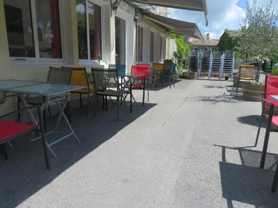 a row of tables and chairs outside of a building at Auberge de la petite casserole in Revest-des-Brousses