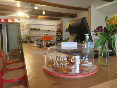 a display of donuts on a counter in a store at Auberge de la petite casserole in Revest-des-Brousses