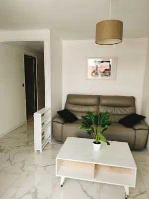 a living room with a couch and a table at Appart 1 ch rénové avec piscine in Morières-lès-Avignon