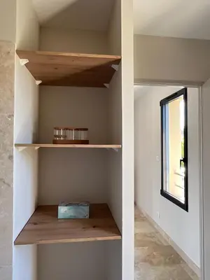 a room with wooden shelves and a window at Villa PERNOISE in Pernes-les-Fontaines