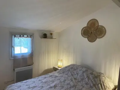 a bedroom with a bed and a window at Mazet provençal in Eyguières