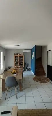 a living room with a table and a dining room at Chez Kristina in Entraigues-sur-la-Sorgue