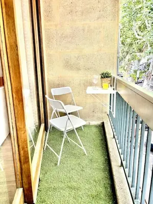 a balcony with two chairs and a table on a balcony at Studio Lumineux avec Terrasse in Aix-en-Provence