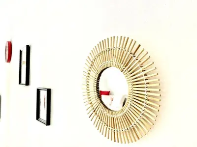 a gold mirror sitting on top of a wall at Studio Lumineux avec Terrasse in Aix-en-Provence
