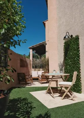 a patio with a table and chairs in a yard at Studio rénové avec belle terrasse in Aix-en-Provence