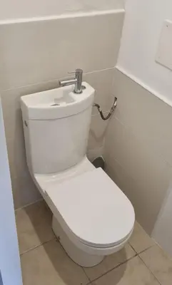 a bathroom with a white toilet in a room at La Passiflore in Mazan