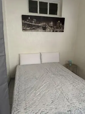 a bed in a bedroom with a picture on the wall at Le Tanneur- Grand Studio 38m2 en centre-ville in Aix-en-Provence