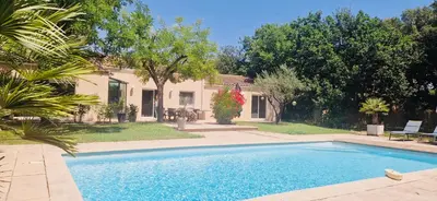 a swimming pool in front of a house at La Maison du Soleil in Saint-Didier