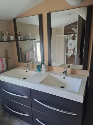 a bathroom with a sink and a large mirror at Jolie petite maison tout proche d avignon in Vedène