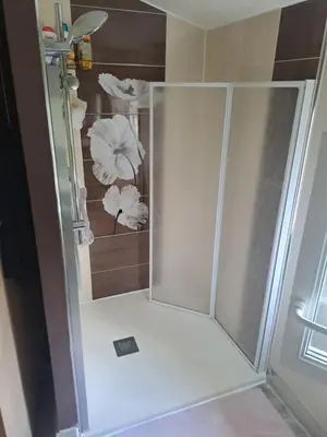 a shower with a glass door in a bathroom at Jolie petite maison tout proche d avignon in Vedène