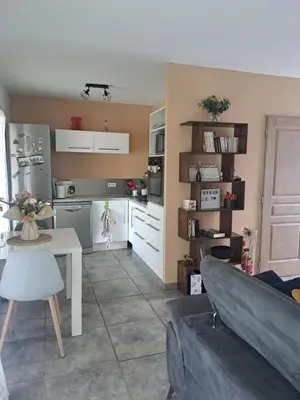 a kitchen with a white table and a white table and a kitchen at Jolie petite maison tout proche d avignon in Vedène