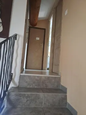 a staircase leading to a door in a building at Jolie petite maison tout proche d avignon in Vedène