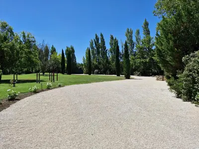 a driveway in a park with trees and grass at La maison de Campagne - RENDEZ-VOUS EN PROVENCE in Monteux
