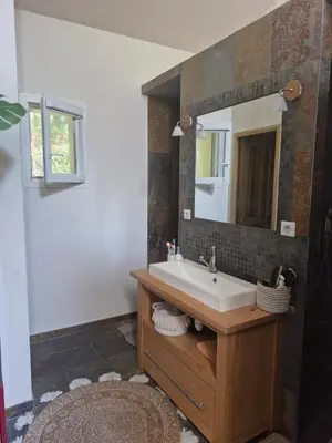 a bathroom with a sink and a mirror at La maison de Campagne - RENDEZ-VOUS EN PROVENCE in Monteux