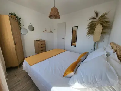 a bedroom with a large white bed with yellow pillows at Pleasant detached villa with private swimming pool for 6 people in Lauris - Luberon. in Lauris