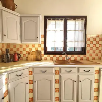 a kitchen with white cabinets and a sink and a window at Villa l'Olivier en Provence 5ch piscine jardin et clim in Lambesc