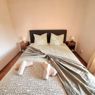 a bedroom with a bed with two slippers on it at Villa l'Olivier en Provence 5ch piscine jardin et clim in Lambesc