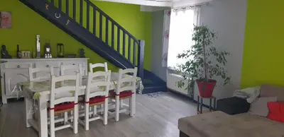 a dining room with a table and chairs and green walls at Chambre étudiant in Morières-lès-Avignon
