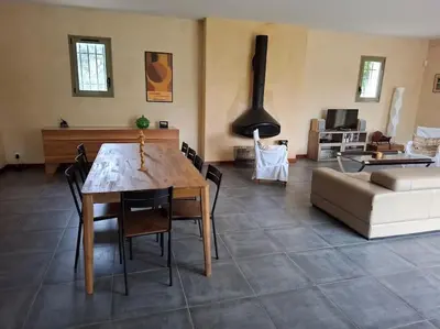 a living room with a table and a couch at La gloriette in Saumane-de-Vaucluse