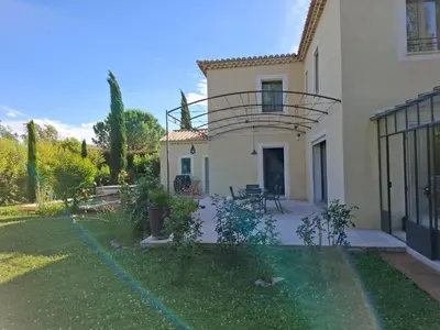 a house with a balcony on top of a yard at La gloriette in Saumane-de-Vaucluse