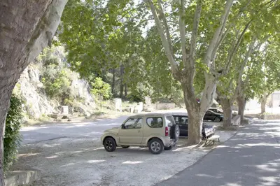 a small car parked next to a tree at Les trois gites in Robion en Luberon