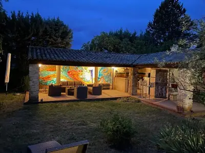 a house with a living room with a patio at night at Le Mas Carradou , Mas de Prestige en campagne in Monteux